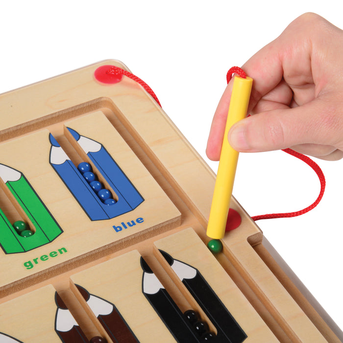 Color sorting toy with wooden frame and colorful markers, hand holding a yellow marker.