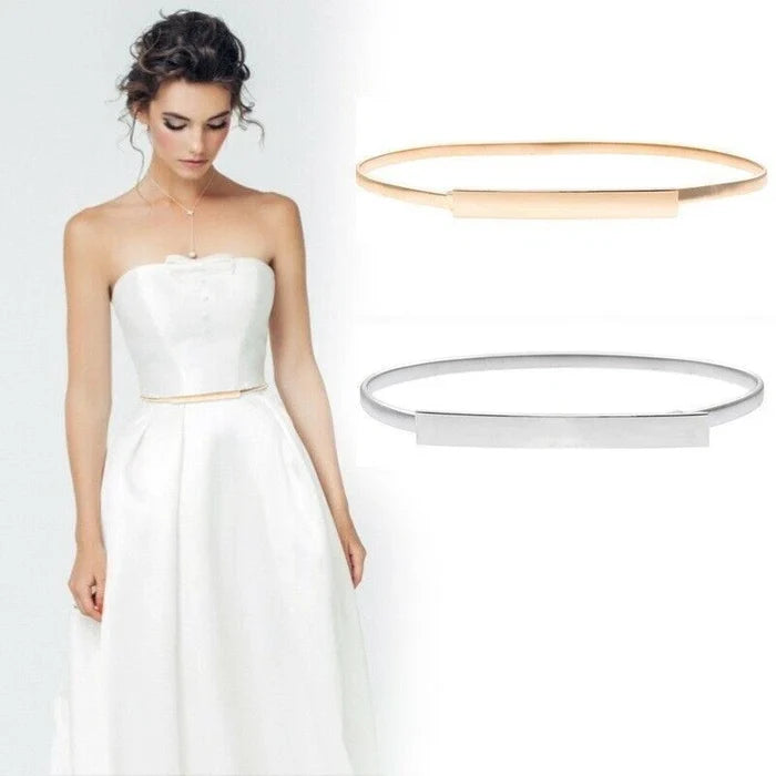 Woman in a white strapless dress with two gold rings displayed above her.
