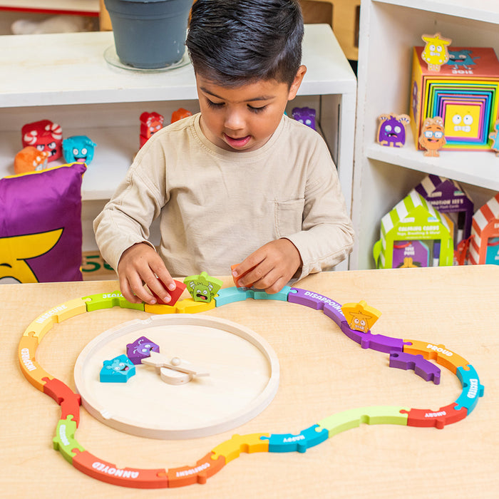 Child playing with a colorful toy on a table.